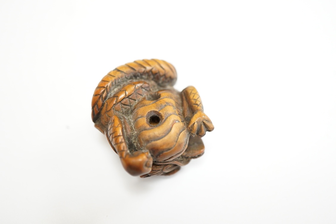 A 19th century Japanese carved wood ‘dragon’ netsuke, 4cm wide
